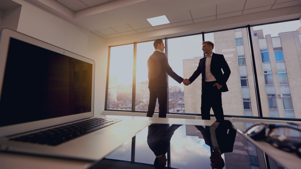 Two men in an office shaking hands